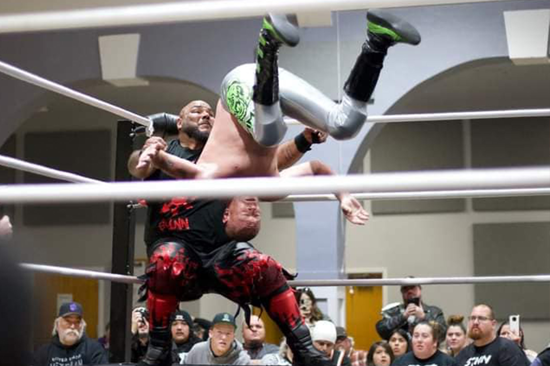 Zack 'PrimeTime' Reeb delivers a powerful cannonball to Nightmare Synn during an intense PCW match at the Oroville Convention Center