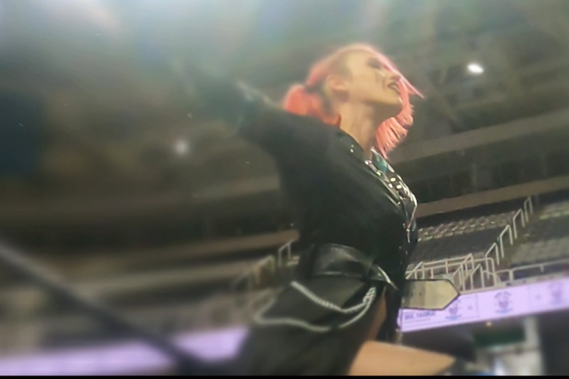 The Pretty Little Psycho Kimberly Diemond triumphantly raises her arms to soak in the crowd's adoration at the San Jose Shark Tank during a PCW event
